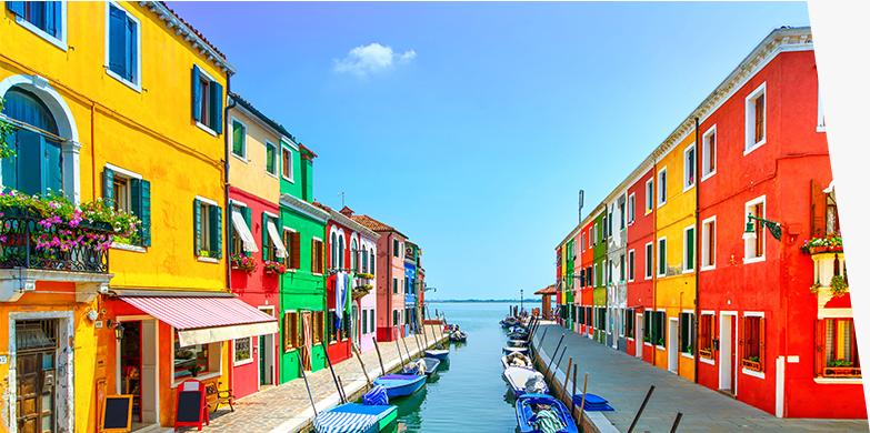 A view of various colorful homes on a canal.